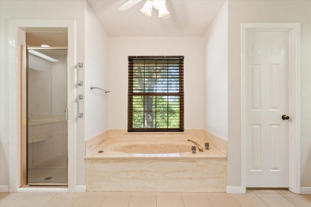 10010 Lost Oak Ridge Dr, Woodway, TX 76712 - full bath featuring a stall shower, tile patterned flooring, a bath, a ceiling fan, and baseboards