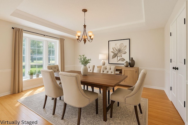 10010 Lost Oak Ridge Dr, Woodway, TX 76712 - dining area with a tray ceiling, a chandelier, light wood finished floors, and baseboards