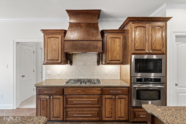 106 Horseguards Ave, Bossier City, LA 71111 - kitchen featuring built in microwave, premium range hood, decorative backsplash, stainless steel gas stovetop, and ornamental molding