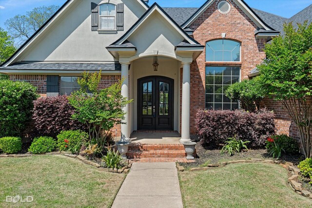 106 Horseguards Ave, Bossier City, LA 71111 - entrance to property featuring a yard, brick siding, roof with shingles, and stucco siding