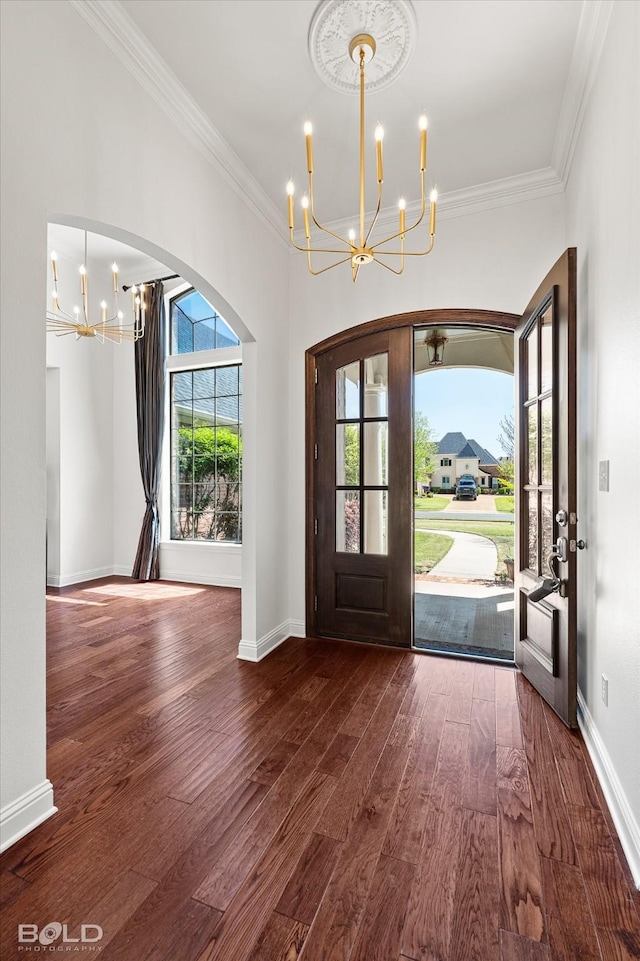 106 Horseguards Ave, Bossier City, LA 71111 - foyer entrance with an inviting chandelier, arched walkways, crown molding, and wood finished floors