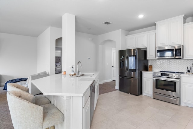 3918 Holly Springs Ln, Kaufman, TX 75142 - kitchen with a kitchen breakfast bar, visible vents, stainless steel appliances, arched walkways, and a sink