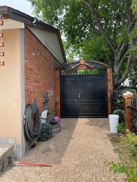 3915 Mather Ct, Dallas, TX 75211 - view of side of property featuring a gate and brick siding
