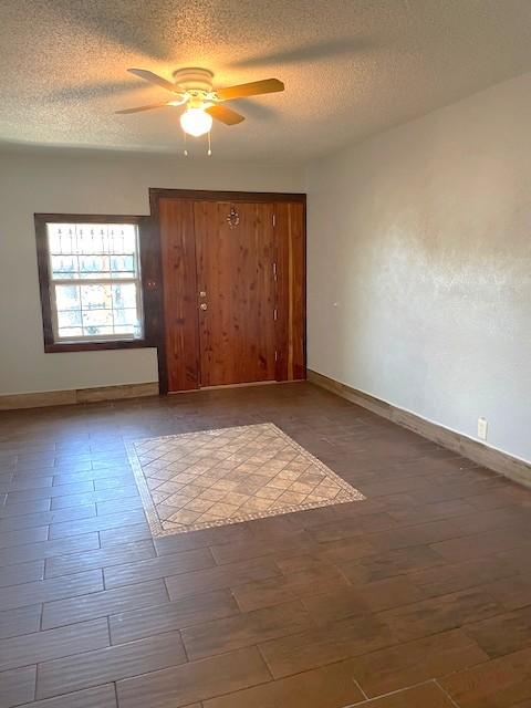 3915 Mather Ct, Dallas, TX 75211 - unfurnished bedroom featuring a textured ceiling, baseboards, a closet, and ceiling fan