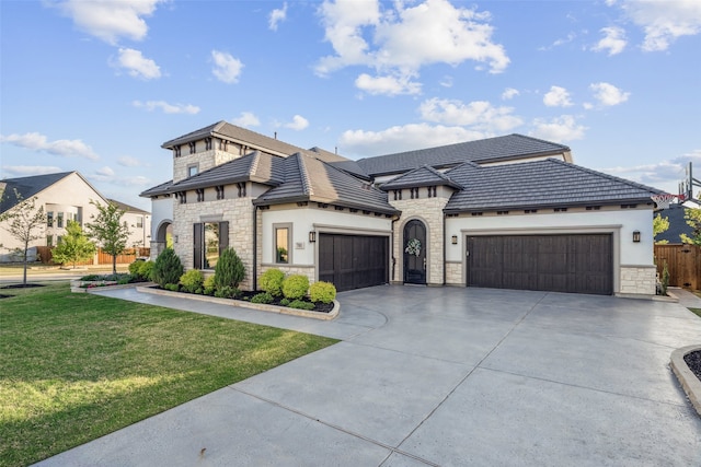 781 Star Meadow Dr, Prosper, TX 75078 - view of front of house with an attached garage, stone siding, driveway, and a front lawn