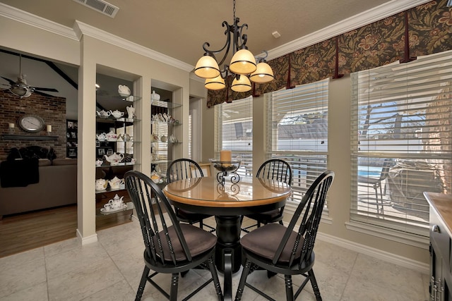 dining room with baseboards, ornamental molding, light tile patterned flooring, visible vents, and ceiling fan with notable chandelier