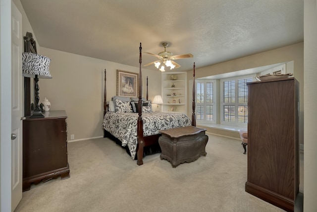 carpeted bedroom featuring baseboards and a ceiling fan