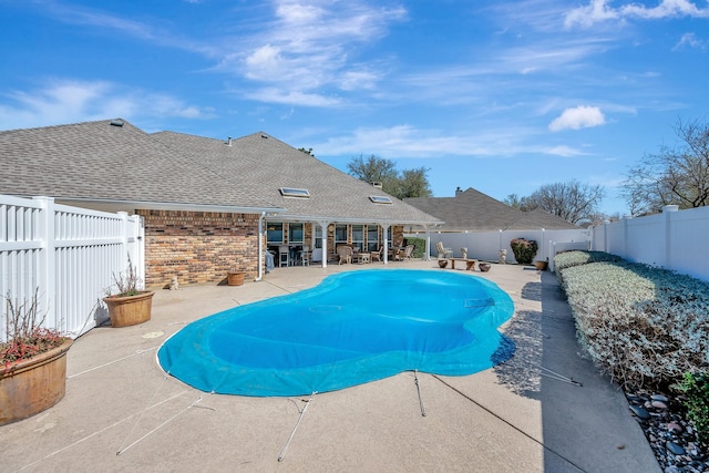 view of pool with a fenced backyard and a patio