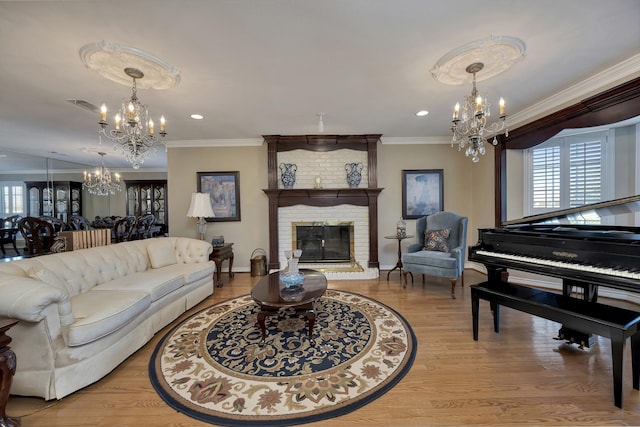 living area featuring a chandelier, crown molding, and plenty of natural light
