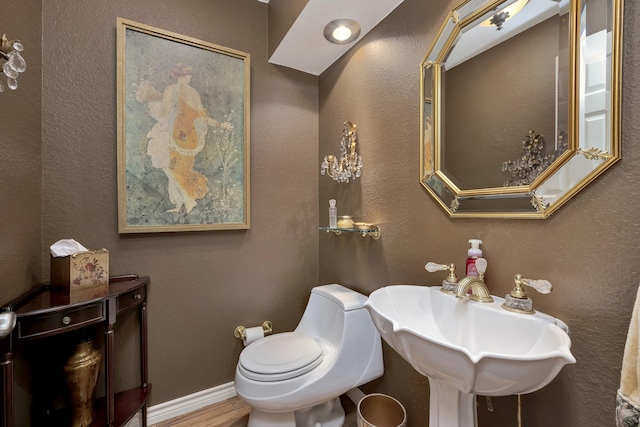 half bath with toilet and a sink