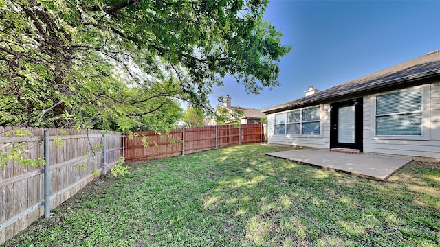 view of yard featuring a patio area and a fenced backyard
