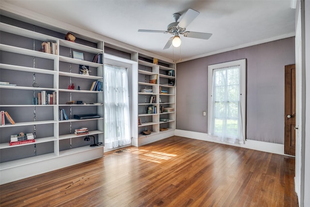 401 Pacific Ave, Terrell, TX 75160 - empty room with built in features, baseboards, a ceiling fan, crown molding, and wood finished floors