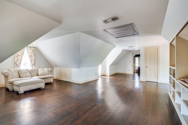 401 Pacific Ave, Terrell, TX 75160 - additional living space featuring visible vents, a healthy amount of sunlight, vaulted ceiling, and dark wood-style floors