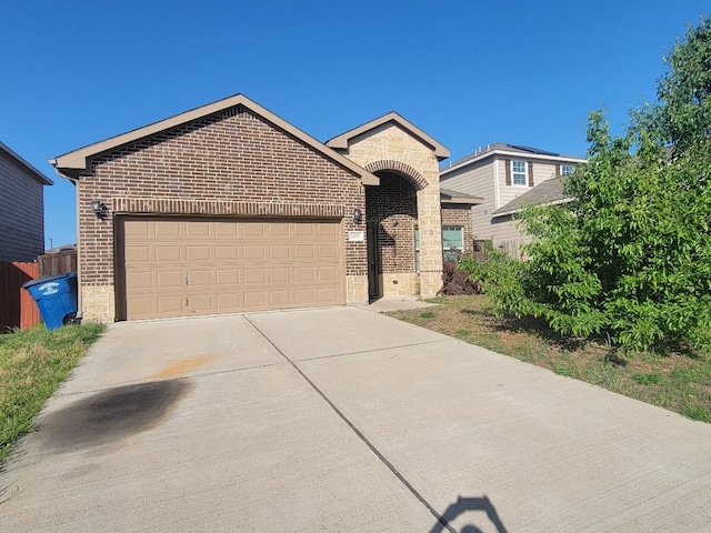 14247 Greenhaw Ln, Dallas, TX 75253 - view of front of house featuring brick siding, driveway, and an attached garage