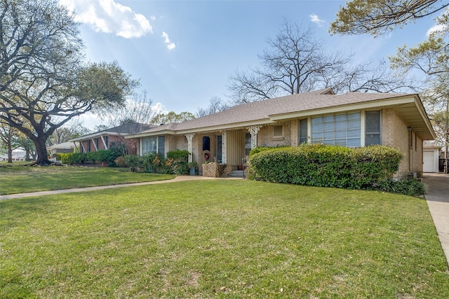ranch-style home featuring a garage, brick siding, and a front lawn
