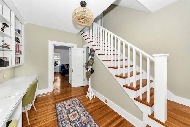 stairs featuring wood finished floors