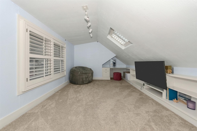 additional living space with baseboards, lofted ceiling, and carpet