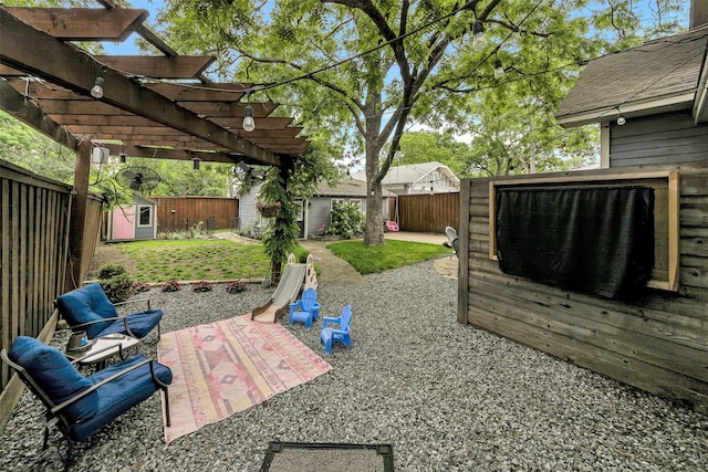 view of patio featuring a fenced backyard, a storage unit, an outbuilding, and a pergola