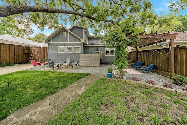 back of property with a yard, a patio, and a fenced backyard