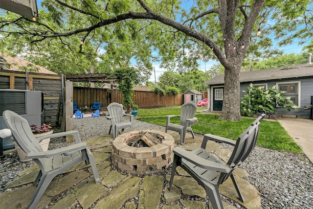 view of patio with a fire pit and fence