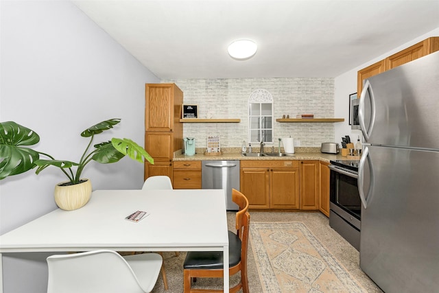 kitchen featuring open shelves, a sink, brown cabinets, and stainless steel appliances
