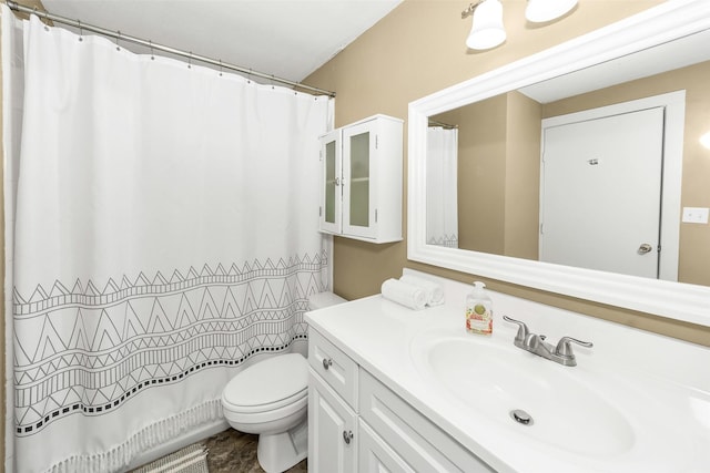 bathroom featuring vanity, toilet, and curtained shower