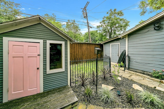 view of shed featuring fence