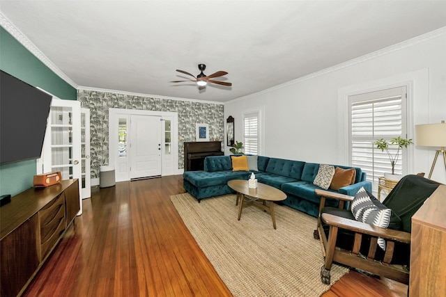 living area featuring crown molding, a ceiling fan, and dark wood finished floors