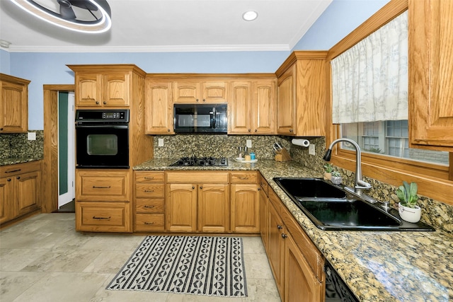 kitchen featuring stone countertops, a sink, black appliances, and tasteful backsplash