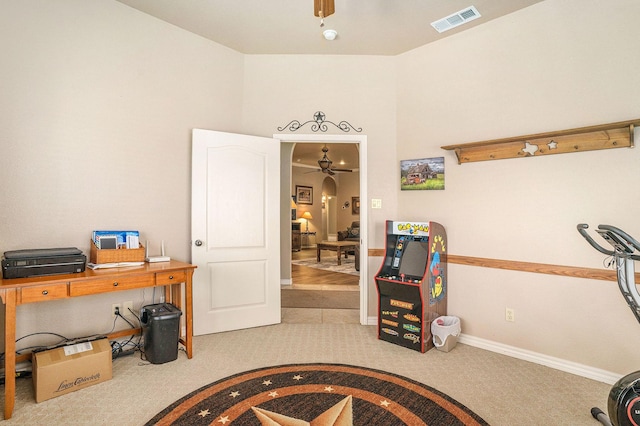 interior space with carpet flooring, visible vents, baseboards, and a ceiling fan