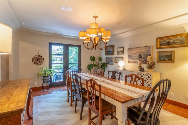 dining space with a chandelier, french doors, baseboards, and tile patterned flooring