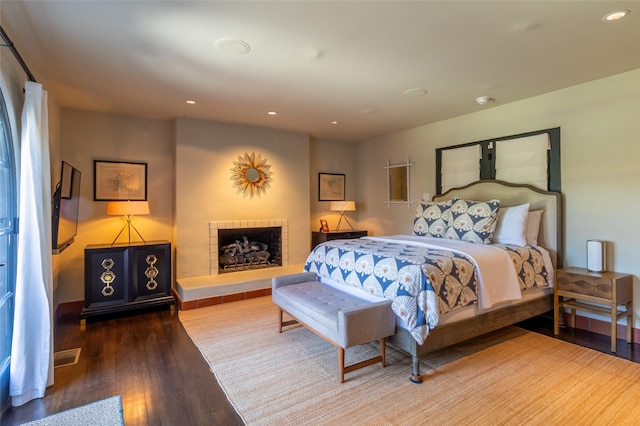 bedroom with recessed lighting and wood finished floors