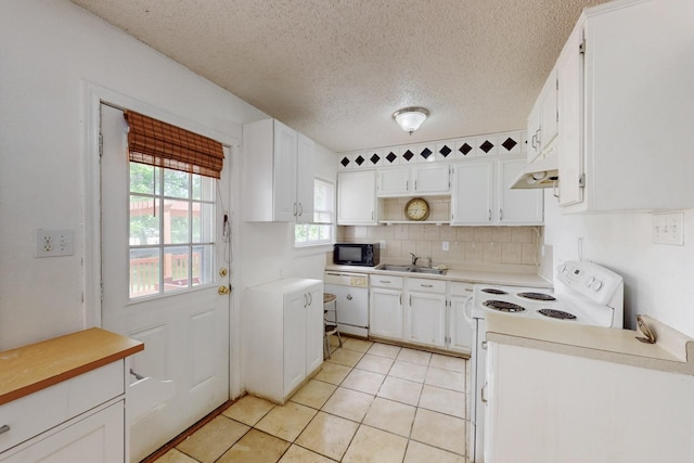 carpeted spare room featuring a textured ceiling, a healthy amount of sunlight, and ceiling fan