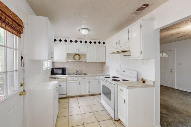 kitchen with a textured ceiling, white cabinetry, a ceiling fan, black microwave, and light tile patterned floors