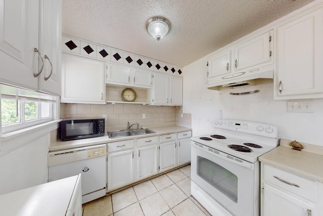 kitchen with white cabinets, washer and clothes dryer, a ceiling fan, white appliances, and light countertops