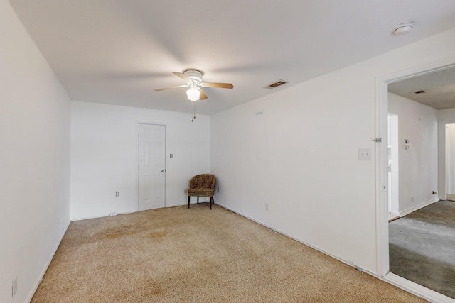 unfurnished room featuring light colored carpet, ceiling fan, and visible vents