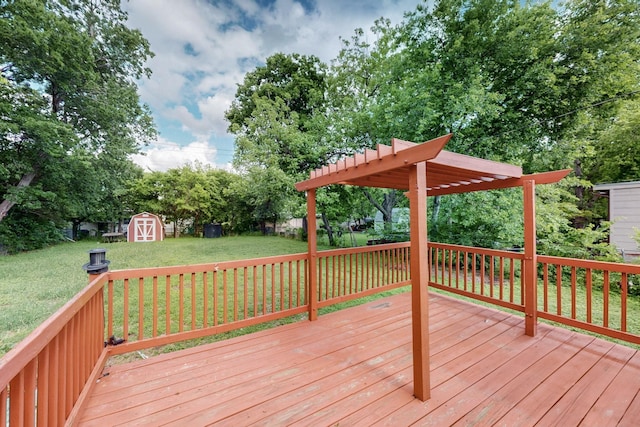wooden deck featuring a lawn, an outdoor structure, a pergola, and a storage shed