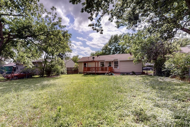 view of yard featuring a wooden deck and fence
