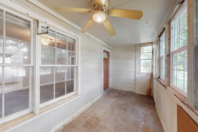 carpeted empty room featuring a ceiling fan and visible vents