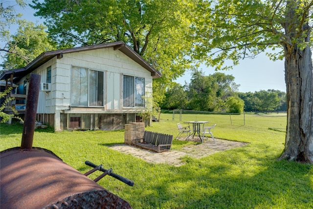 exterior space with a yard, a patio, cooling unit, and fence