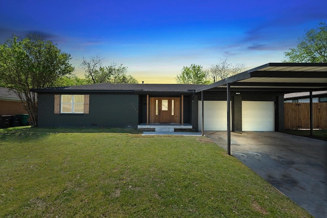 view of front of house featuring a front lawn, concrete driveway, fence, a garage, and brick siding