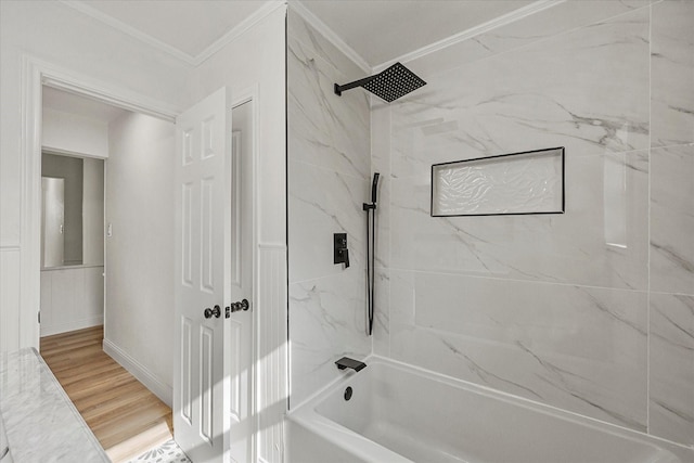 bathroom with crown molding, baseboards, and  shower combination