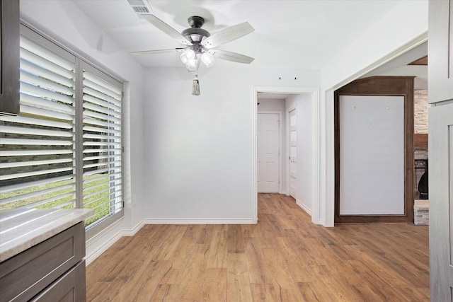 813 Grinnell Dr, Richardson, TX 75081 - empty room featuring a ceiling fan, light wood-style flooring, and baseboards