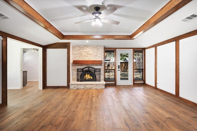 813 Grinnell Dr, Richardson, TX 75081 - unfurnished living room with a tray ceiling, a ceiling fan, light wood-style floors, a stone fireplace, and baseboards