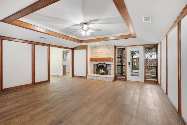 813 Grinnell Dr, Richardson, TX 75081 - unfurnished living room with ceiling fan, a raised ceiling, a fireplace, wood finished floors, and baseboards