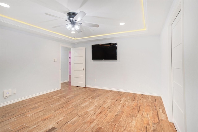 813 Grinnell Dr, Richardson, TX 75081 - empty room with a tray ceiling, baseboards, light wood-type flooring, ceiling fan, and recessed lighting