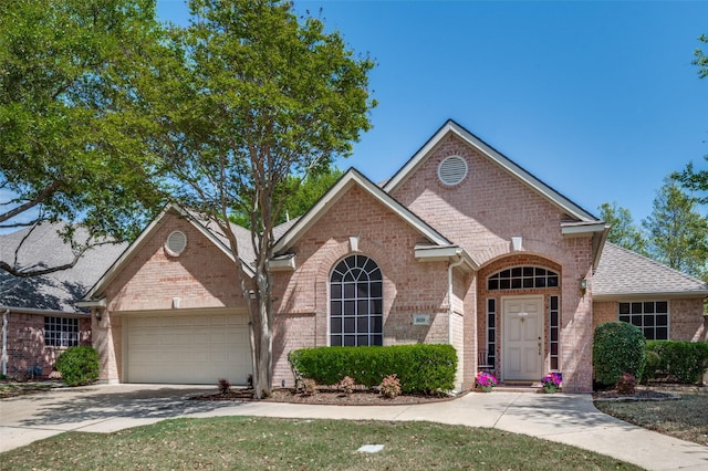 809 Lake Point Cir, Mckinney, TX 75072 - view of front of home featuring brick siding, driveway, and an attached garage
