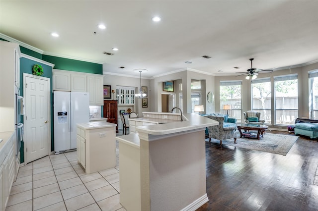 809 Lake Point Cir, Mckinney, TX 75072 - kitchen featuring crown molding, white refrigerator with ice dispenser, recessed lighting, and a kitchen island with sink