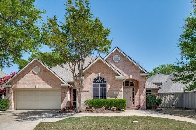 809 Lake Point Cir, Mckinney, TX 75072 - view of front of property with brick siding, an attached garage, fence, and concrete driveway