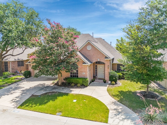 809 Lake Point Cir, Mckinney, TX 75072 - view of front of home with a shingled roof, concrete driveway, a front yard, and brick siding